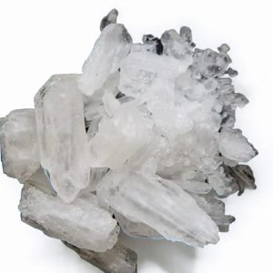Clear methamphetamine crystals in solid form arranged together on a plain white surface. Crystal Meth For Sale Canada