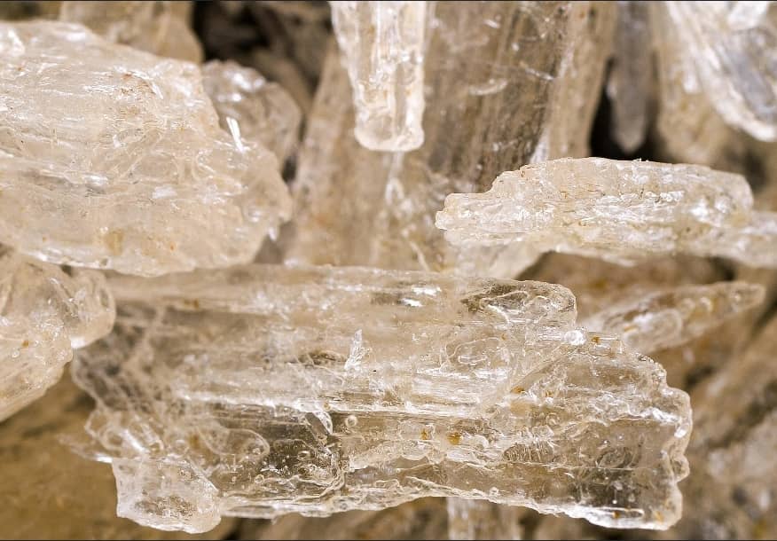 Crystal Meth For Sale Canada. Crystal methamphetamine fragments shown in a detailed close-up view, highlighting their clear crystalline appearance.